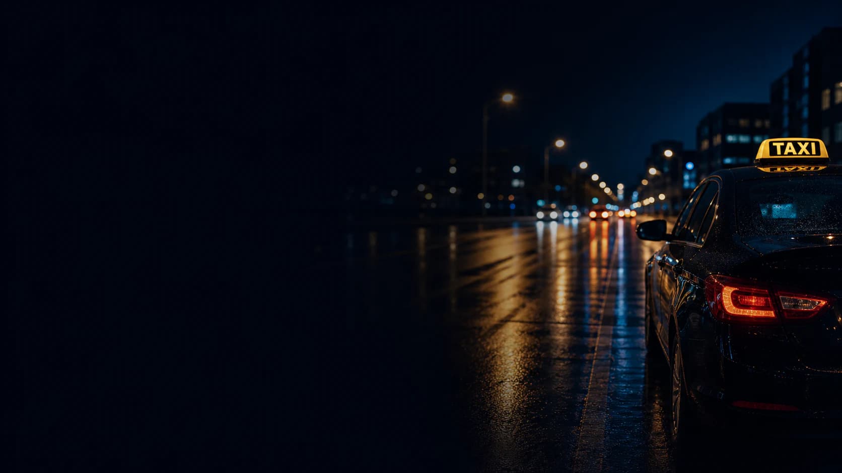 A professional driver beside a taxi at night in a city.